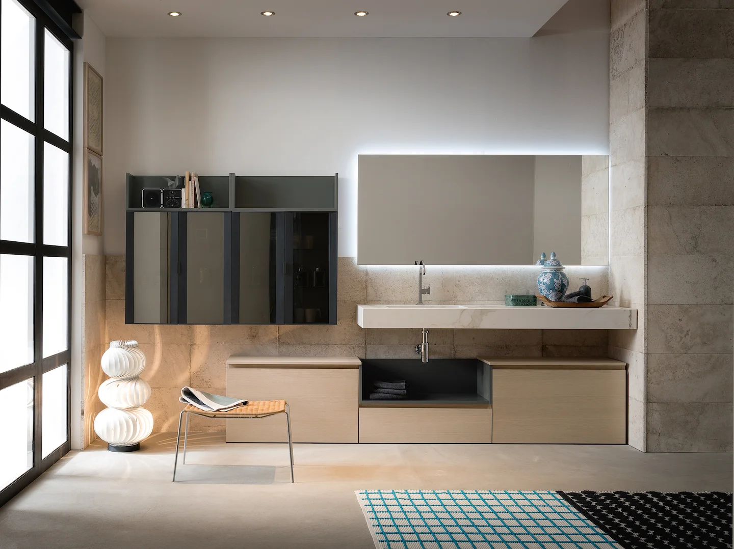 A compact, custom bathroom vanity featuring floating cabinets and a marble countertop.