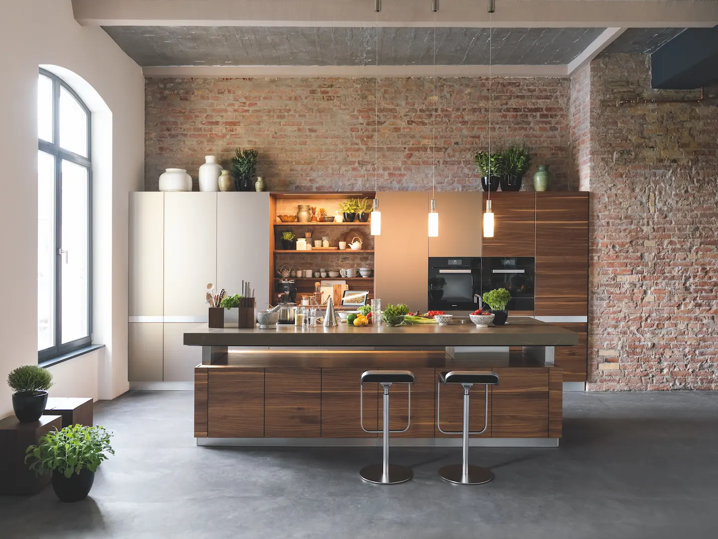 A modern, open concept kitchen with a solid wood island. 