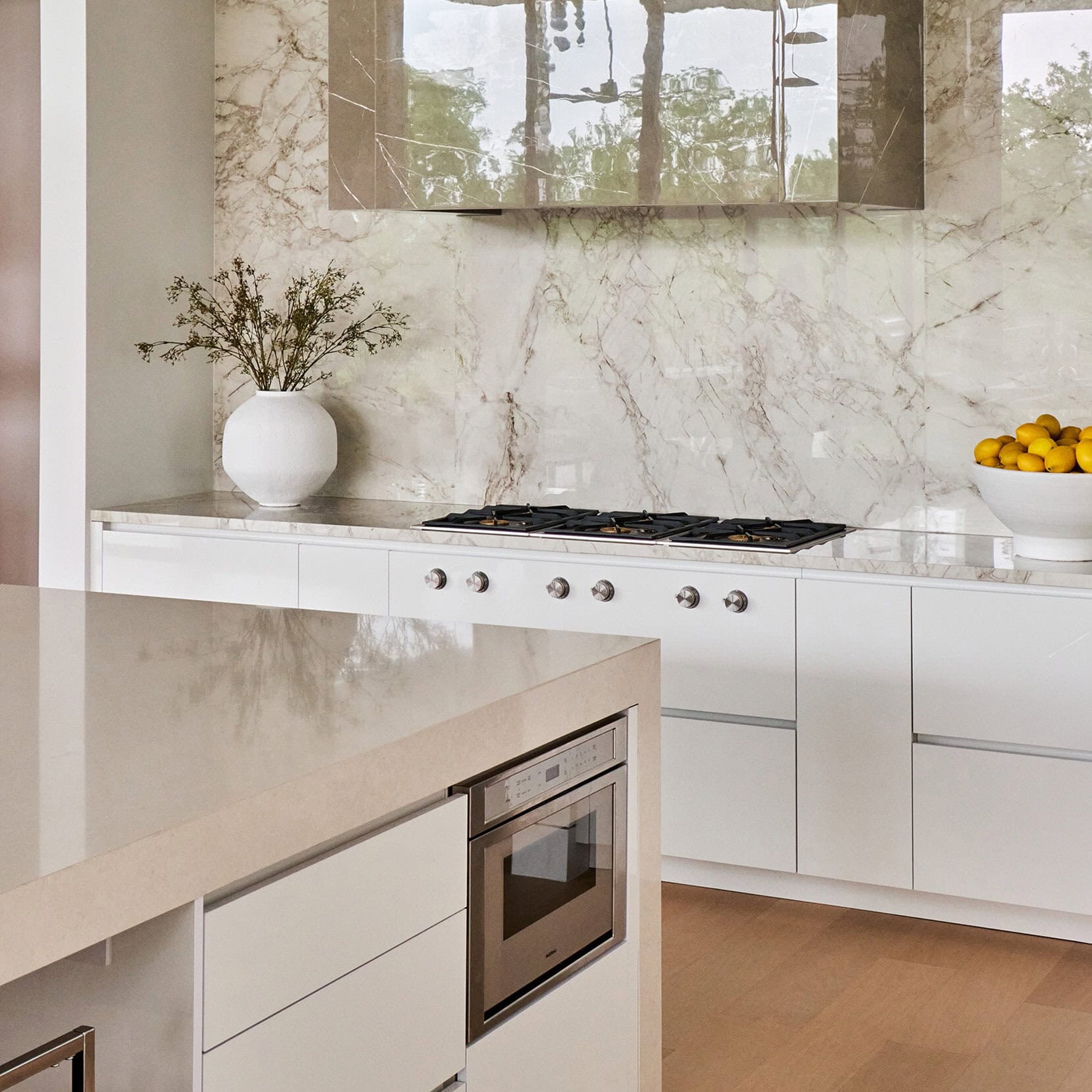 Freestanding tub and floor-to-ceiling view with custom cabinetry details in The Dominion luxury bath