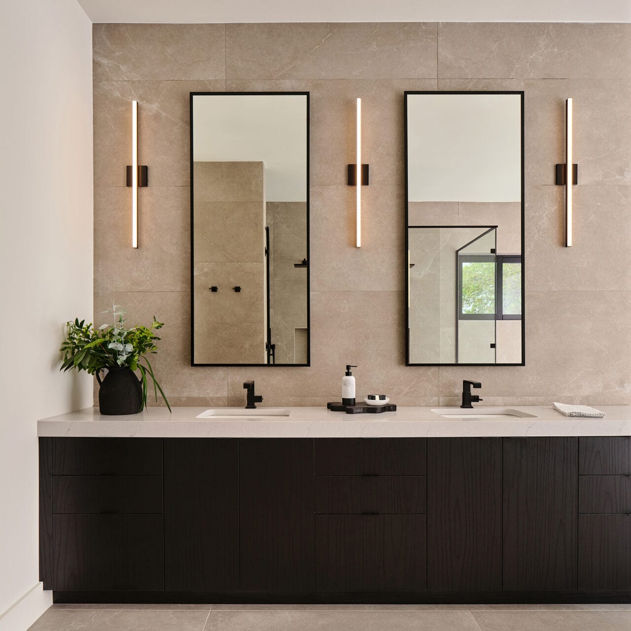 Bespoke bathroom vanity cabinetry with double sinks and stone backsplash in The Dominion, San Antonio