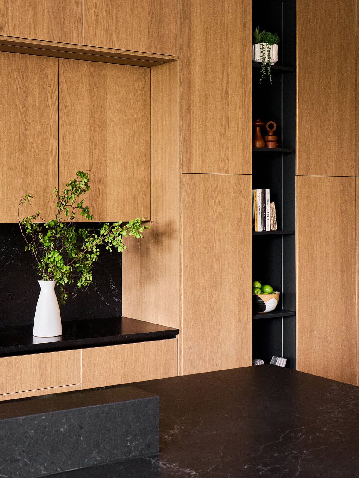 Custom kitchen cabinetry with vertical storage niche in The Dominion, San Antonio