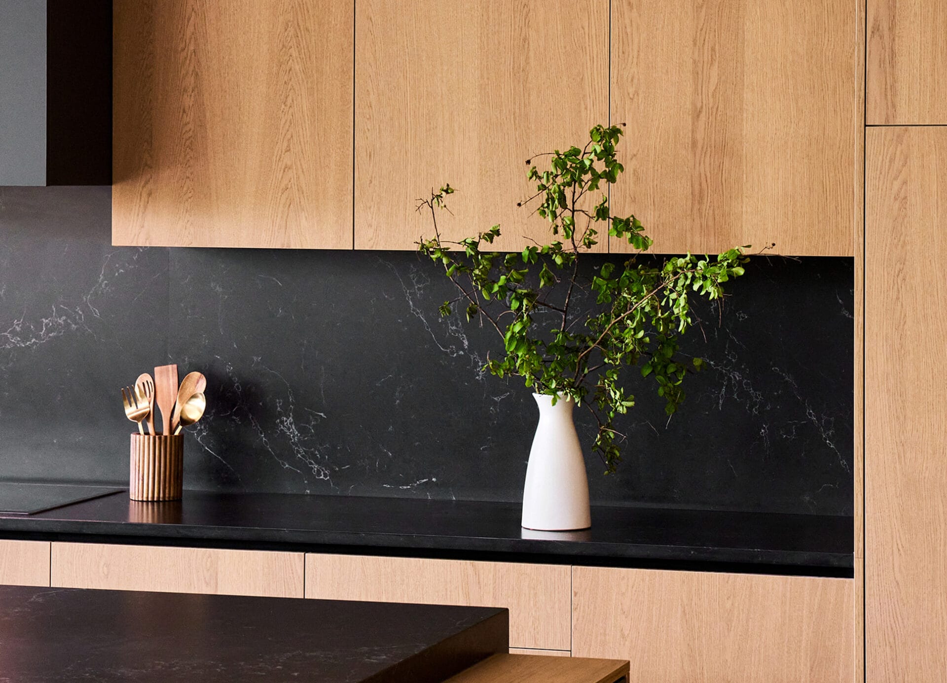 Custom kitchen cabinetry detail with stone backsplash in The Dominion, San Antonio